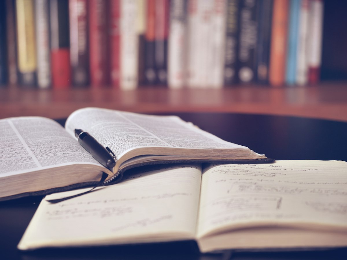 Notebook and reference materials laid out for creative project planning